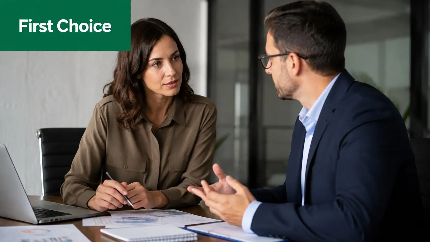 A professional woman and man discussing financial documents and asset purchase strategies in a modern office.